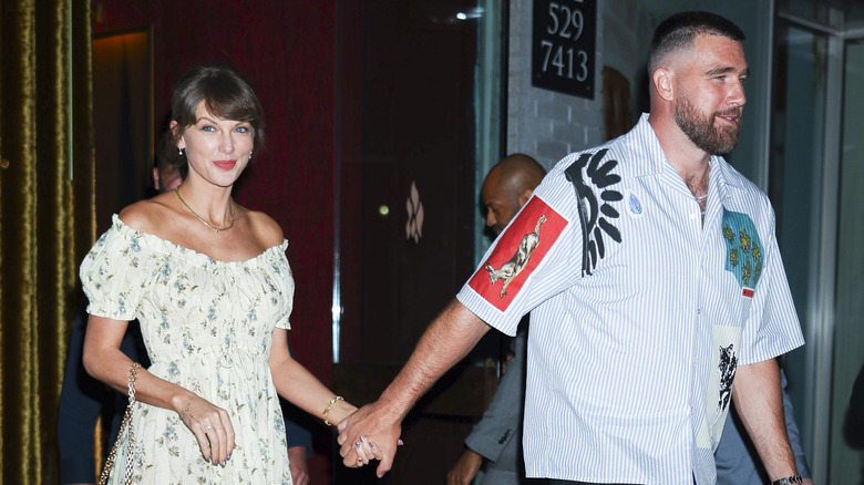 Taylor Swift and Travis Kelce holding hands