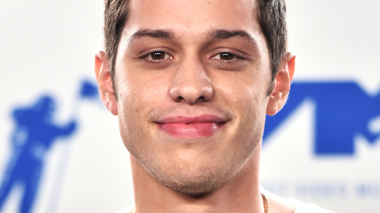 Pete Davidson gives slight smile 