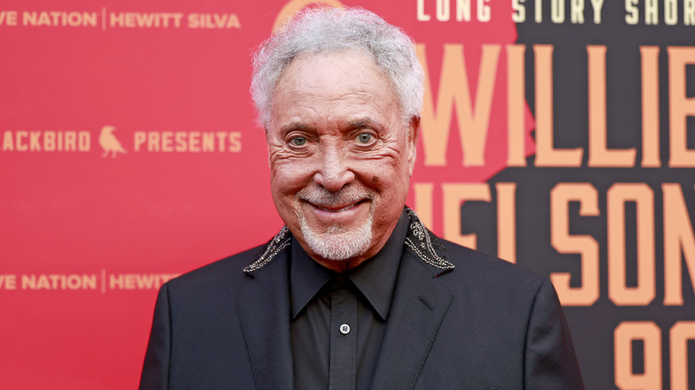 Tom Jones posing on the red carpet.
