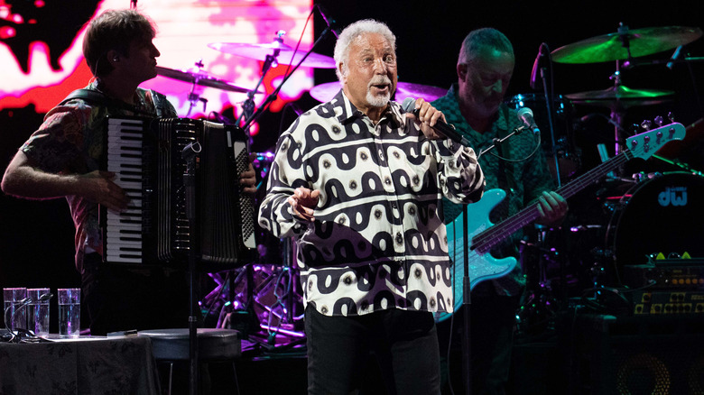 Tom Jones performing on stage in 2023.