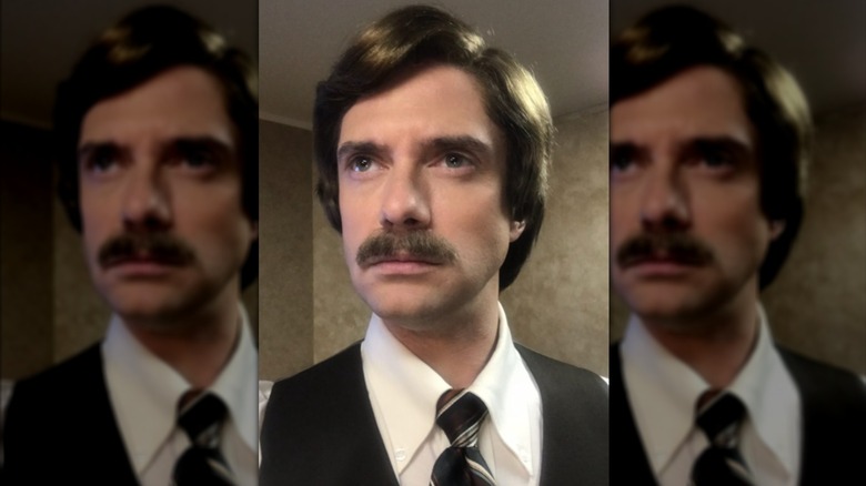 Topher Grace posing for a selfie in his "BlacKkKlansman" hair and makeup.
