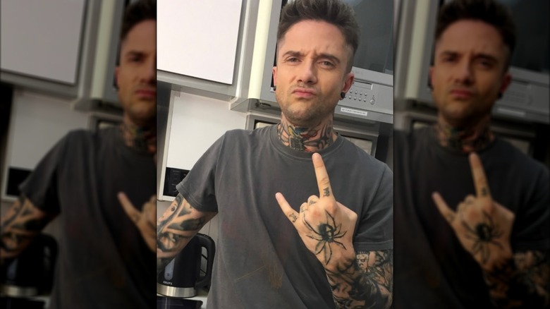 Topher Grace posing in his "Workaholics" hair and makeup.