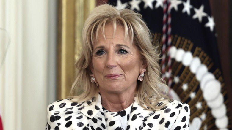 Dressed in a polka dot number, Jill Biden makes a face as she looks away from the camera