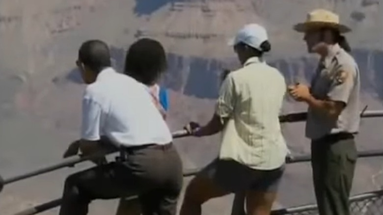 The Obama family members, including Michelle Obama, lean on a rail at the Grand Canyon