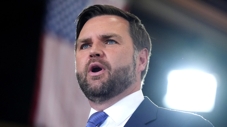 JD Vance backlit by a bright light at an event