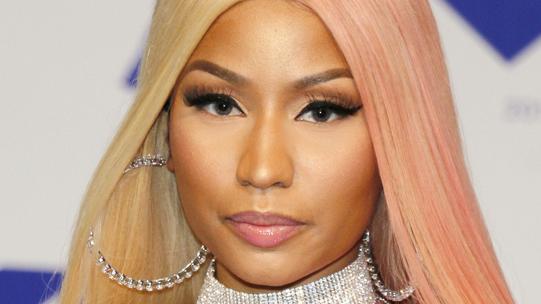Nicki Minaj with pink in her hair, diamond hoop earrings