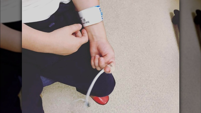 Rocky Prinze wearing hospital wristband