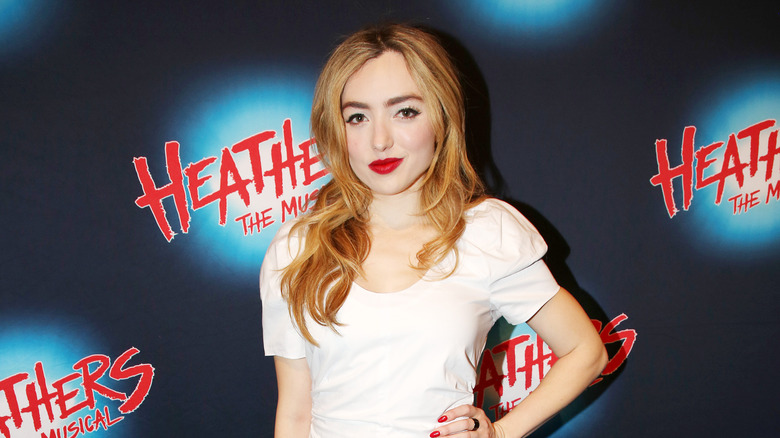 Peyton List smiles and wears red lipstick