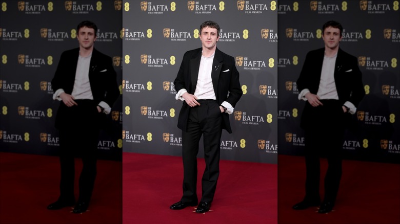 Paul Mescal posing at the 2026 BAFTAs in a black suit