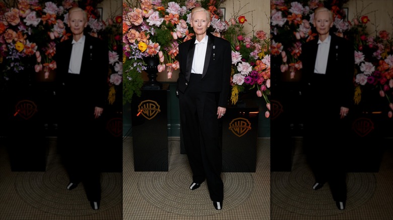 Tilda Swinton posing in a Chanel suit at the 2026 BAFTAs