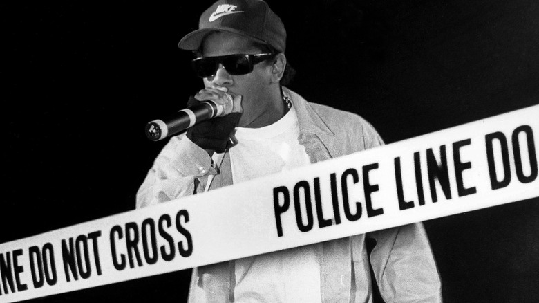 Eazy-E rapping, police tape in front of him