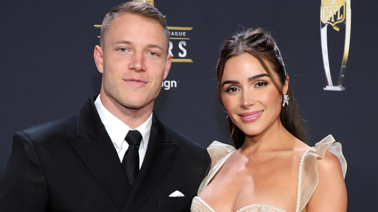 Christian McCaffrey and Olivia Culpo posing