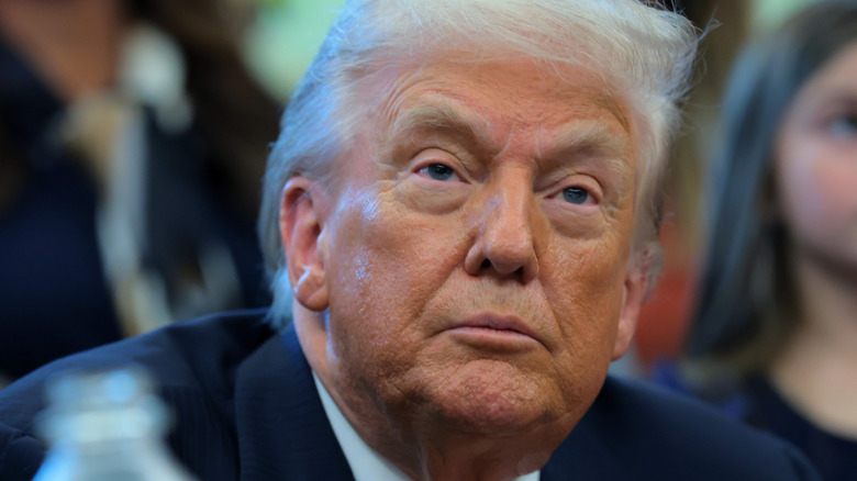 President Donald Trump looks on