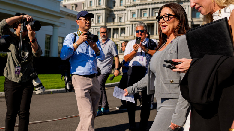 Lori Chavez-DeRemer flanked by photojournalists at the White House.