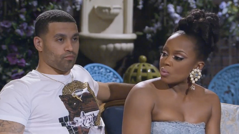 Apollo Nida and Phaedra Parks on a couch