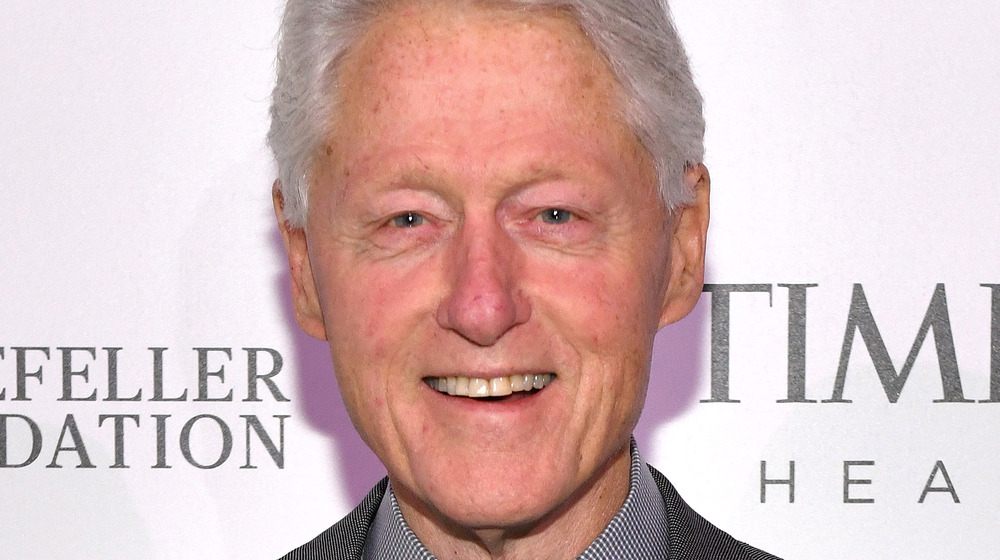 Bill Clinton smiling on the red carpet