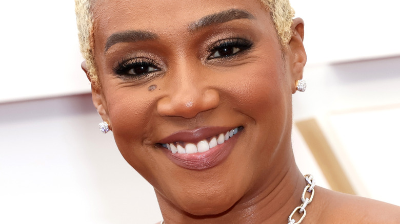 Tiffany Haddish smiling on the the Oscars red carpet