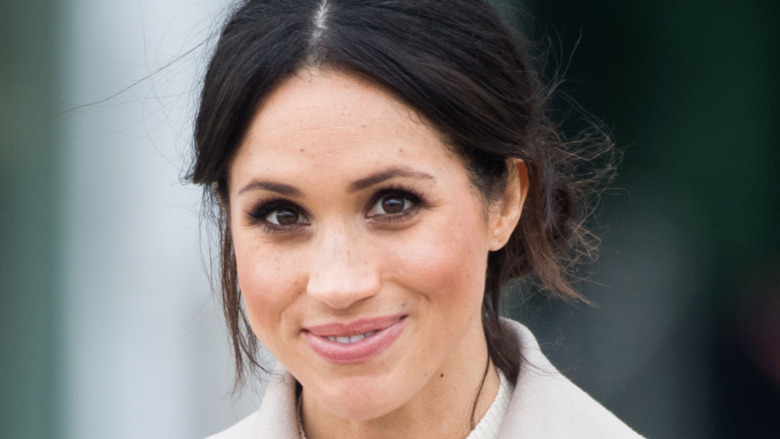 Meghan Markle smiling for a photo