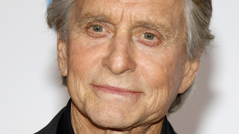 Micheal Douglas with a neutral expression