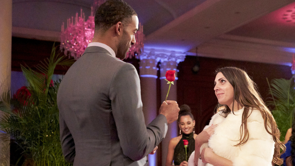 Matt James hands Victoria Larson a rose 