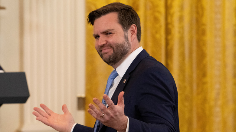 JD Vance shrugs animatedly at a press conference.