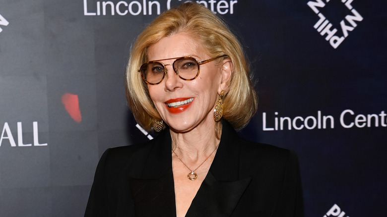 Christine Baranski smiling in tinted glasses