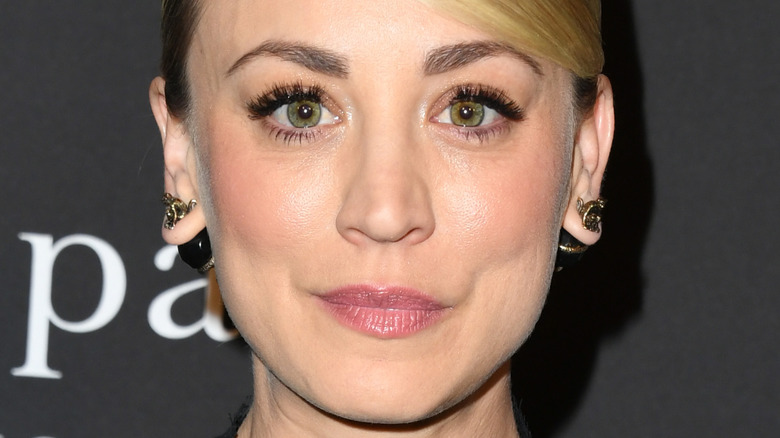 Kaley Cuoco posing sternly at event