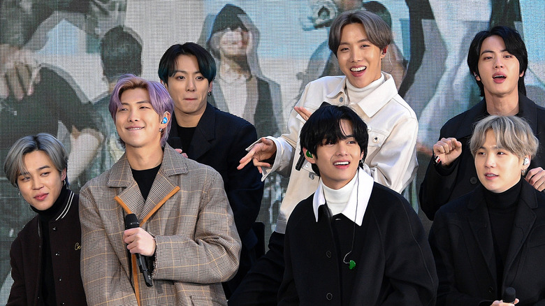 BTS posing in front of screen