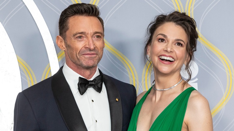 Hugh Jackman and Sutton Foster pose close to each other while all smiles on the red carpet.