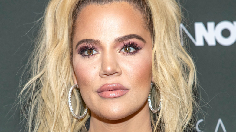 Khloé Kardashian wearing hoop earrings