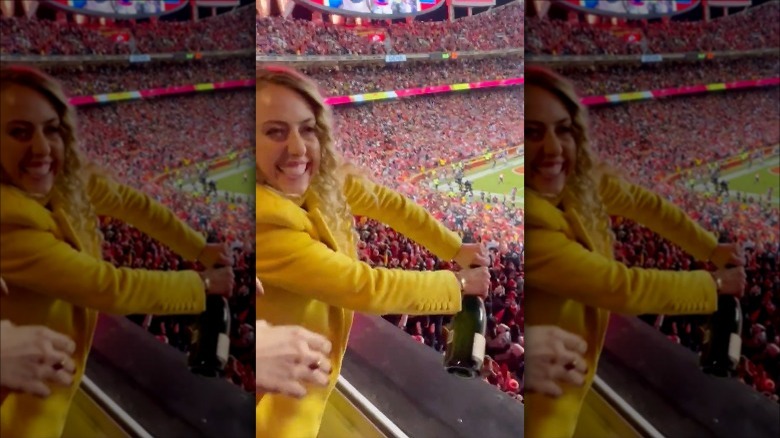 Brittany Mahomes uncorking bottle