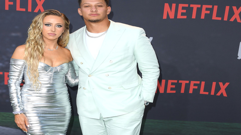 Patrick and Brittany Mahomes posing for pictures