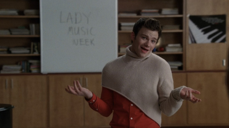 Kurt shrugging in his turtleneck poncho in episode of "Glee"