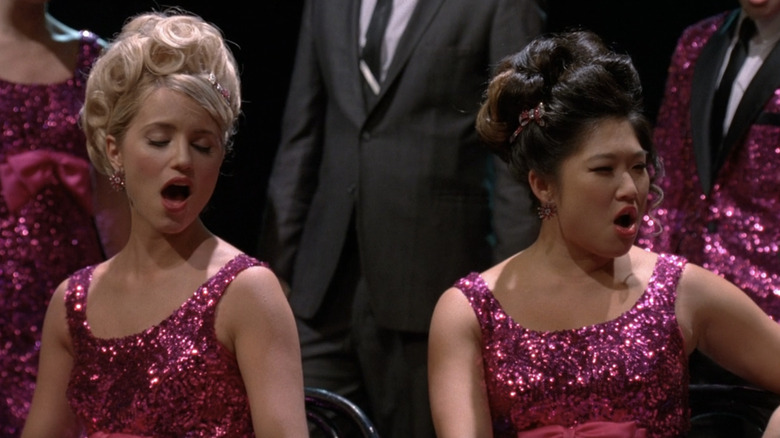 Quinn and Tina wearing sparkly, pink dresses while singing "It's All Over" on "Glee"