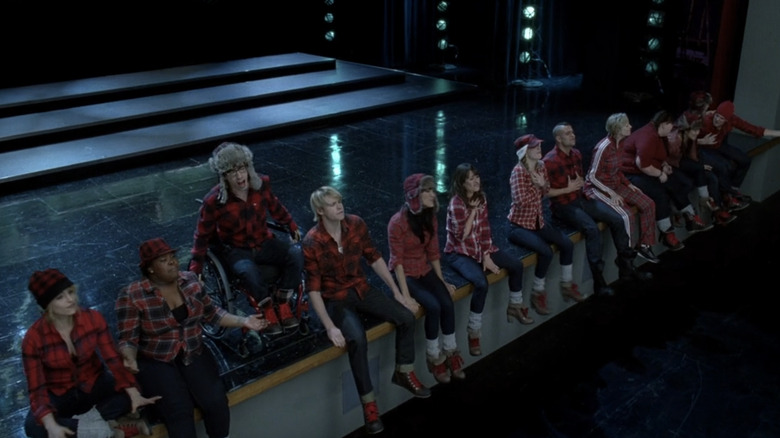 New Directions and Sue all wear red plaid outfits while covering "Sing" on "Glee"