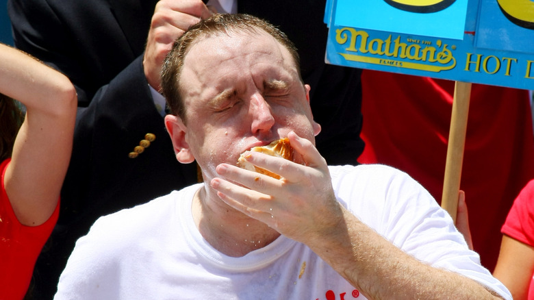 Joey Chestnut binge eats hot dogs