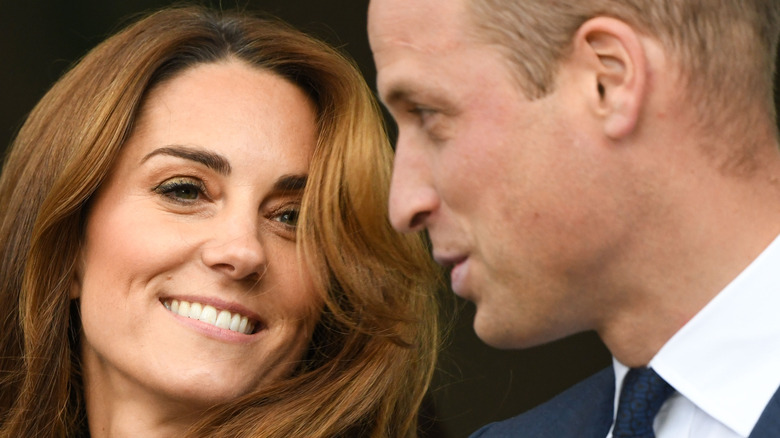 Kate Middleton smiling and Prince William talking