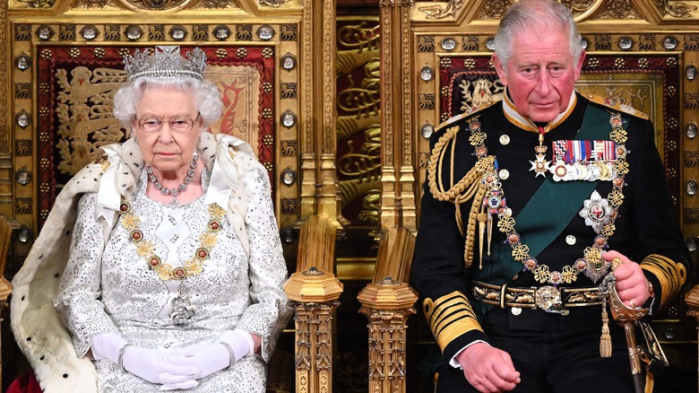 Queen Elizabeth and King Charles seated, posing 