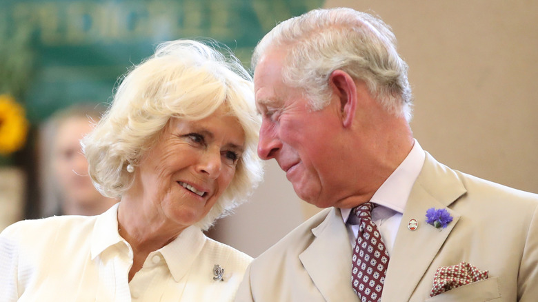 King Charles III and Camilla at an event, smiling close
