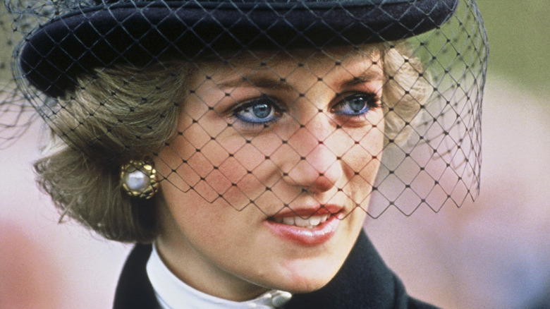 Princess Diana at an event, with black hat and veil