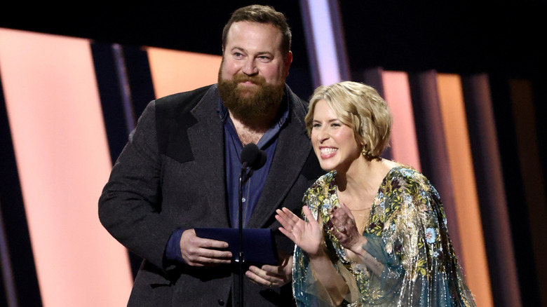 Ben and Erin Napier smiling in front of a microphone at an award show