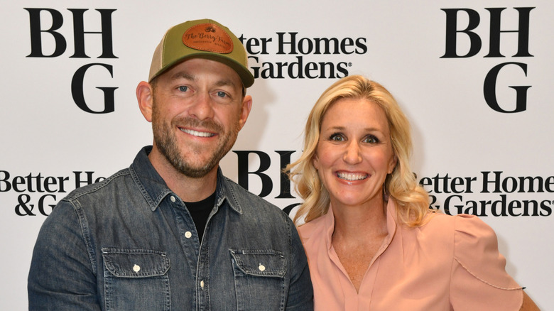 Dave Marrs wearing a denim shirt and Jenny Marrs wearing a blush shirt as they smile next to each other.