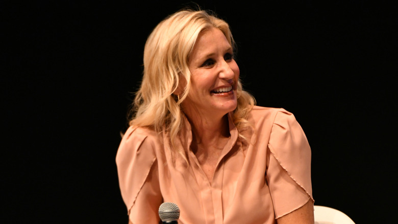 Jenny Marrs smiling and looking off to the side in a blush shirt with tulip-style sleeves.