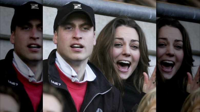 Prince William wearing baseball cap and Kate Middleton cheering