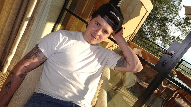 Brooklyn Beckham wearing backwards hat