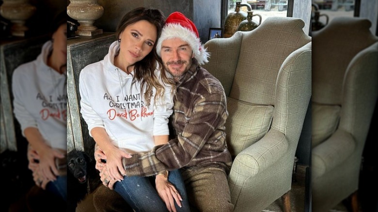 Victoria Beckham sitting in David Beckham's lap