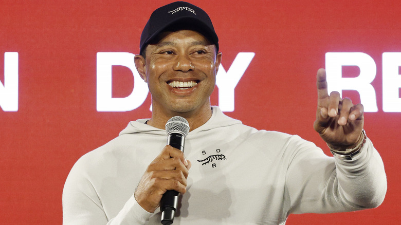 Tiger Woods holding a mic