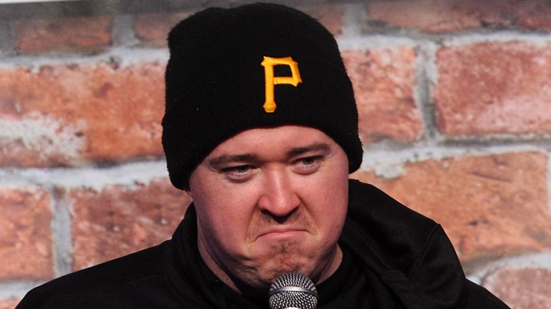 Shane Gillis frowning on stage