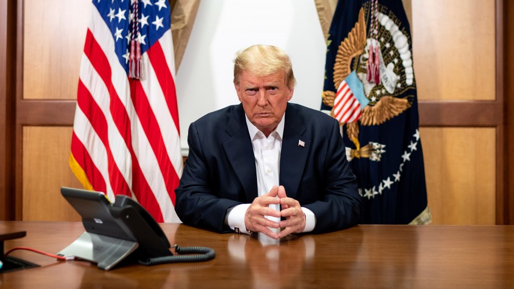 Donald Trump sitting at desk