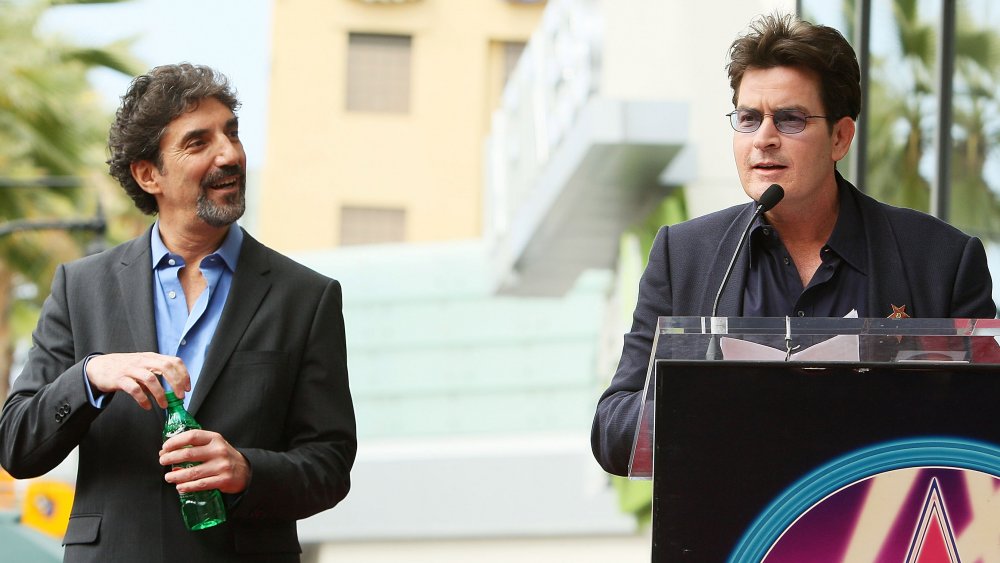 Chuck Lorre standing next to Charlie Sheen as he gives speech